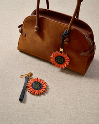 Close-up of STICKYZOO Sunflower Charm — full-grain French Alran goatskin from Tarn, France. Layered sunflower petals with stitched centre. 3-day handmade piece.