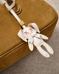 RABBIT CHARM charm styled on a bag — a small, specific piece that turns a simple bag into a personal one.