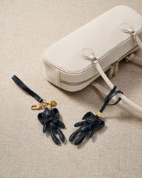 Close-up of the rabbit charm — hand-cut and hand-stitched panels of French Alran goatskin. Every layer by hand.
