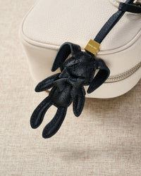 RABBIT CHARM charm styled on a bag — a small, specific piece that turns a simple bag into a personal one.
