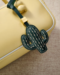 STICKYZOO Cactus Charm — hand-cut, hand-stitched saguaro silhouette with cream cross-stitch in French Alran goatskin. Designed in Amsterdam.