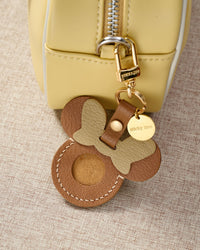 Tan Mickey AirTag holder — precision-cut cavity fits one Apple AirTag snugly. Real French Alran goatskin, stitched by hand.