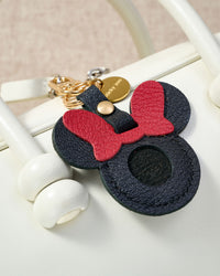 Mickey silhouette AirTag holder — precision-cut cavity fits one Apple AirTag snugly. Real French Alran goatskin, stitched by hand.