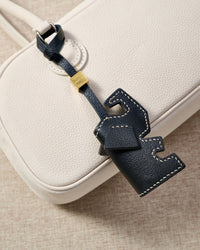 ELEPHANT CHARM charm styled on a bag — a small, specific piece that turns a simple bag into a personal one.