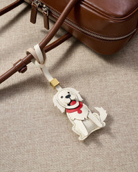 Close-up of handmade Golden Retriever leather bag charm — hand-layered paws, ears, and body panels in French Alran goatskin. STICKYZOO 5-day build.