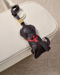 Handmade Golden Retriever leather bag charm on a handbag — 5 days of hand-cutting, stitching, and layering in French Alran goatskin. STICKYZOO.