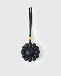 STICKYZOO Night Flower Charm — all-black French Alran goatskin with padded dimensional petals, tonal centre, gold-plated hardware. 3-day handmade piece.