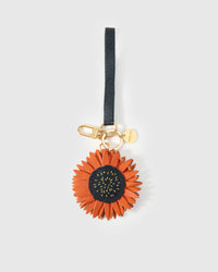 STICKYZOO Sunflower Charm in rust orange over dark navy French Alran goatskin. Hand-cut, hand-stitched. Designed in Amsterdam.