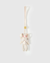 RABBIT CHARM charm handmade from French Alran genuine goatskin — A cream rabbit with red X eyes and a leather bow.. Three days by hand. Arrives in luxury gift packaging. Designed in Amsterdam.