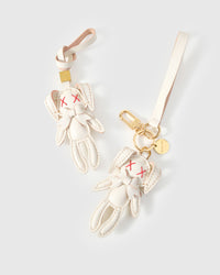 Both editions of the rabbit charm — leather strap loop for bags, or 18K gold-plated keychain clip.