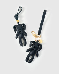Both editions of the rabbit charm — leather strap loop for bags, or 18K gold-plated keychain clip.