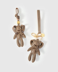 Both editions of the rabbit charm — leather strap loop for bags, or 18K gold-plated keychain clip.