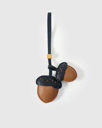 STICKYZOO Acorns Charm — warm tan bodies with dark navy caps and contrast dash stitching, French Alran goatskin, 18K gold-plated hardware. 3-day handmade piece.