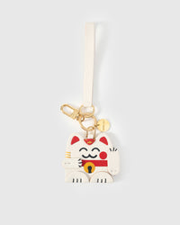 Tight close-up of the Maneki Neko (lucky cat) charm face — every detail in real French Alran leather, layered and stitched by hand.