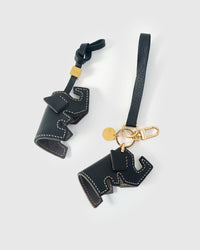 Both editions of the elephant charm — leather strap loop for bags, or 18K gold-plated keychain clip.
