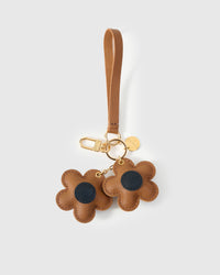 STICKYZOO Twin Flowers Charm — caramel French Alran goatskin petals with dark navy centres, gold keychain clip and engraved coin tag. 3-day handmade piece.