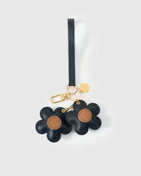 STICKYZOO Twin Flowers Charm — navy French Alran goatskin petals with warm tan centres, gold keychain clip and engraved coin tag. 3-day handmade piece.