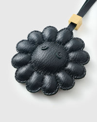 STICKYZOO Night Flower Charm clipped to a handbag — handmade French Alran goatskin in all-black. 3-day artisan build.