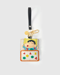 Shinchan nap charm on a bag, side angle — loved by thousands of character-charm fans. Real French leather, 3 days by hand.