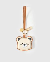 Close-up of the Toast Bear face — cream ivory leather, caramel crust edge stitched around, dark ears, white muzzle with dark nose. Every panel by hand.
