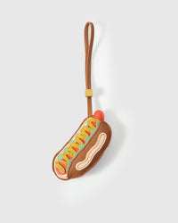 Hot Dog charm handmade from French Alran genuine goatskin and French suede — real full-grain leather from Tarn, since 1903. 3 days of hand-cutting, hand-stitching, hand-layering. Arrives in luxury gift packaging. Designed in Amsterdam.