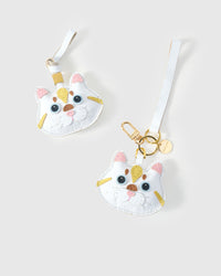 Both editions of the Light Silver Tabby side by side — leather strap loop for bags, or 18K gold-plated keychain clip.