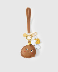 Chicken wing charm on a bag, side angle — real French leather, 3 days by hand.