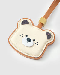 Both editions of the Toast Bear — leather strap loop for bags, or 18K gold-plated keychain clip.