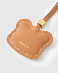 Toast Bear charm on a bag, side angle — rated 4.9★ by thousands of buyers. Real French Alran leather, 3 days by hand.