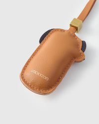 Handmade Dachshund Sausage Pup leather bag charm clipped to a handbag — French Alran goatskin, 5-day artisan build. STICKYZOO Amsterdam design.