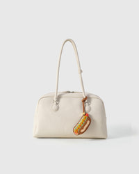 Every panel of the hot dog charm is cut by hand and stitched through real French leather. Layered slowly for depth — no prints, no stamps.