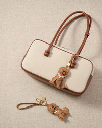 Handmade Golden Retriever leather bag charm on a handbag — 5 days of hand-cutting, stitching, and layering in French Alran goatskin. STICKYZOO.