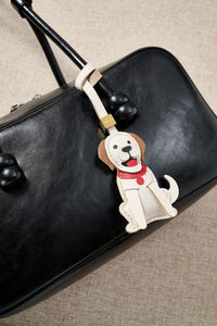 Close-up of handmade Golden Retriever leather bag charm — hand-layered paws, ears, and body panels in French Alran goatskin. STICKYZOO 5-day build.