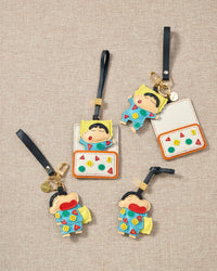 Shinchan nap charm on a bag, side angle — Real French leather, 3 days by hand.
