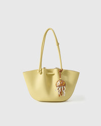 Both editions of the jellyfish charm — leather strap loop for bags, or 18K gold-plated keychain clip.