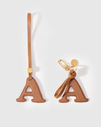 Every edge of the A is cut by hand from French Alran goatskin and stitched through real leather. Three days per piece. Small-batch, made to be kept.