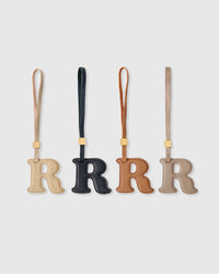 R initial charm handmade from French Alran genuine goatskin leather. Three days of hand-cutting, layering and stitching. A thoughtful gift for names starting with R — Rose, Ryan, Ruby, Rafael, River. Arrives in luxury gift packaging. Designed in Amsterdam.