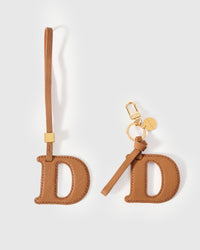 Every edge of the D is cut by hand from French Alran goatskin and stitched through real leather. Three days per piece. Small-batch, made to be kept.