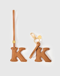 Every edge of the K is cut by hand from French Alran goatskin and stitched through real leather. Three days per piece. Small-batch, made to be kept.