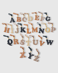 ALPHABET charm handmade from French Alran goatskin and French suede — real full-grain French leather from Tarn, since 1903. Three days of hand-cutting, hand-stitching, hand-layering. Arrives in luxury gift packaging. Designed in Amsterdam.