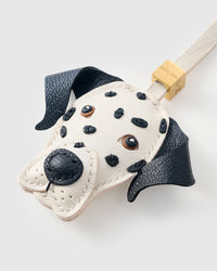 Handmade Dalmatian Luxe leather bag charm on a leather bag — 7 days of hand-cutting, stitching, and layering in French Alran goatskin. STICKYZOO.
