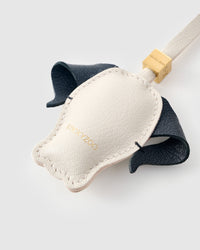 Handmade Dalmatian Luxe leather bag charm clipped to a handbag — French Alran goatskin, individually placed black spots. STICKYZOO.