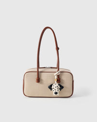 Handmade Dalmatian Luxe leather bag charm styled on a handbag — French Alran goatskin, 18K gold-plated hardware. STICKYZOO.