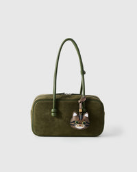 Tabby cat charm on an olive-green suede crossbody bag, front — real French leather, made to be carried on the bag that sees every day.