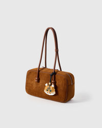 Ginger Maine Coon charm styled on a rich brown suede top-handle bag. 5,000+ reviews across STICKYZOO — real French leather, 3 days by hand.