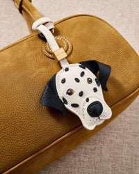 Close-up of handmade Dalmatian Luxe leather bag charm — each black spot hand-cut from full-grain French Alran goatskin and placed by hand. STICKYZOO 7-day build.