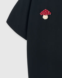 Back detail of Mushroom T-Shirt in black showing single plush mushroom