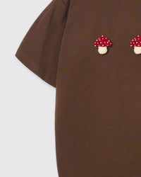 Side view of Mushroom T-Shirt in brown showing sleeve and plush detail