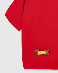 Detail of plush dachshund on body of STICKYZOO red Dachshund Parade T-Shirt showing hand-stitched 3D detail