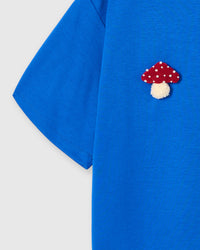 Back detail of Mushroom T-Shirt in blue showing single plush mushroom